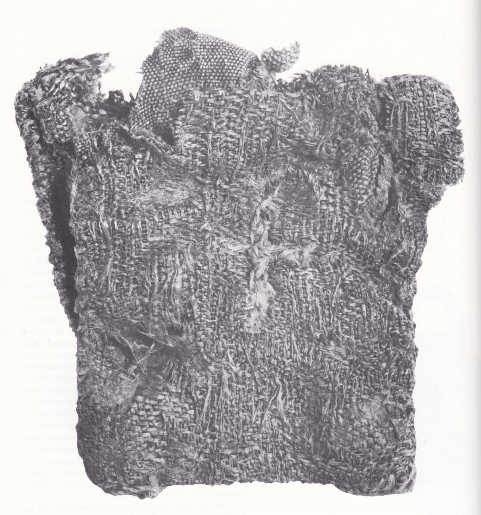black and white image of a silk bag with a cross embroidered on it. Extant from the 10th century.
