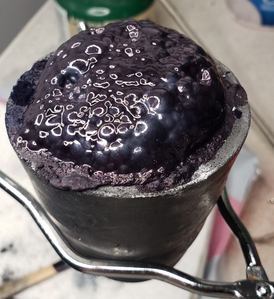 Small clay crucible with bubbling indigo