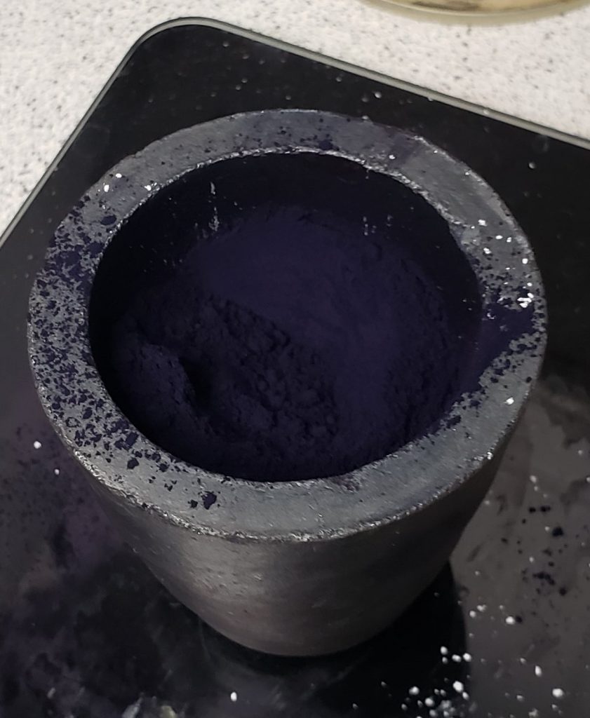indigo powder in a clay crucible