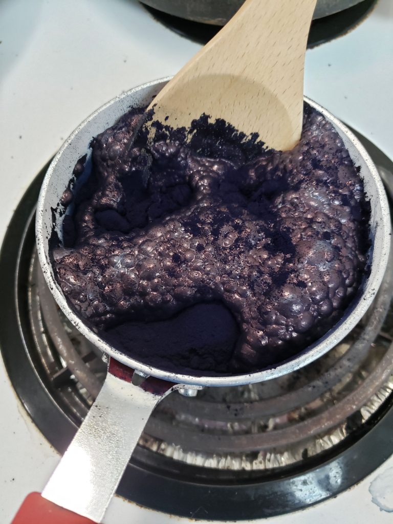 Small pot filled with dark blue liquid