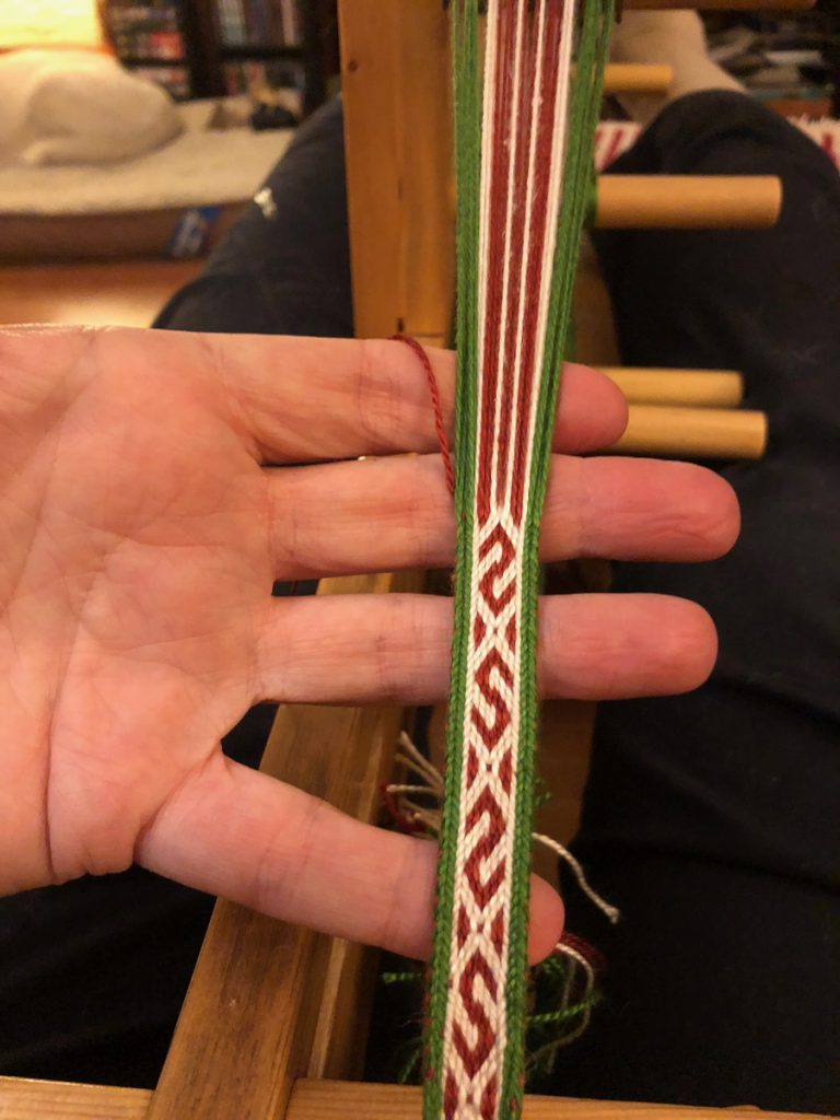 red, green and white tablet woven band