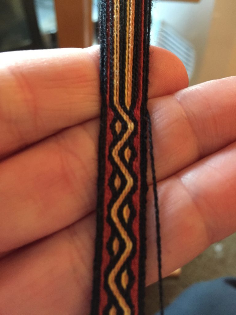 Red and yellow tablet woven band