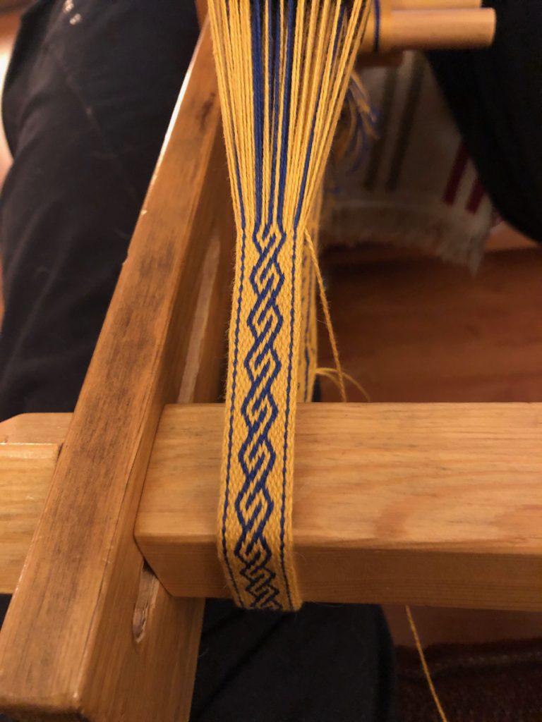 yellow and blue tablet woven band