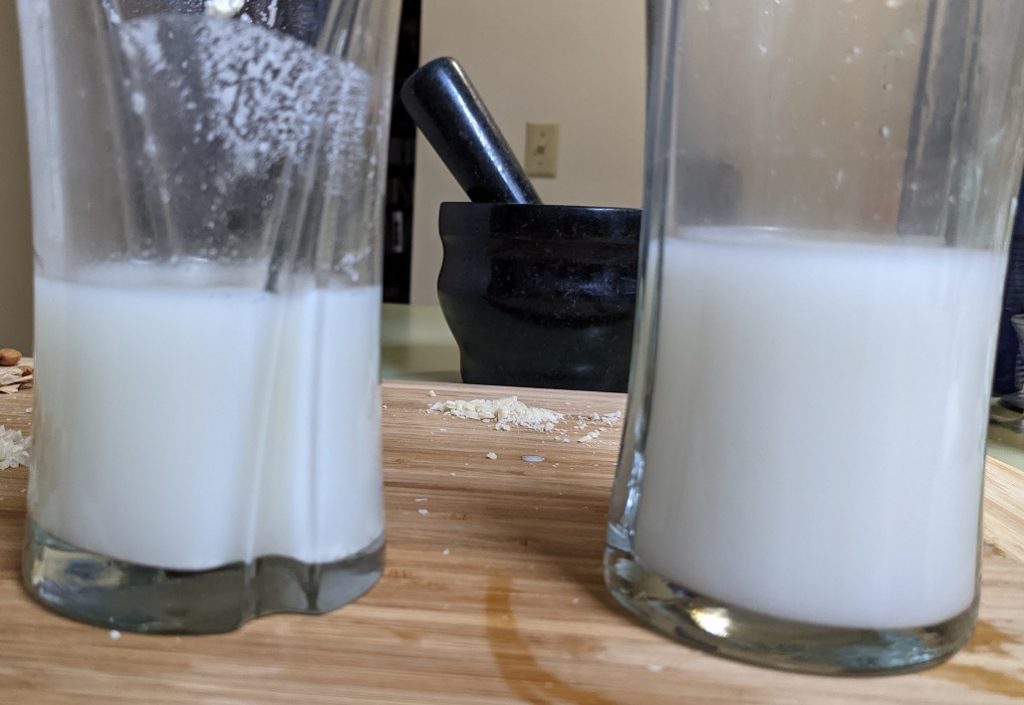 2 glasses containing thin white liquid