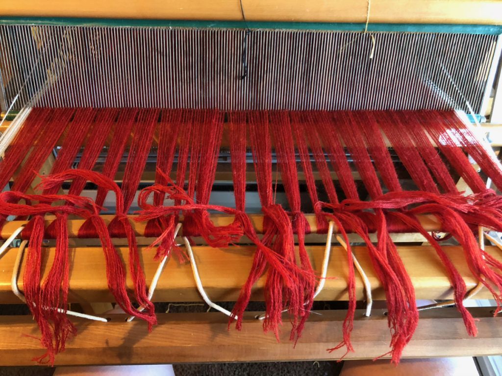 red thread tied on loom