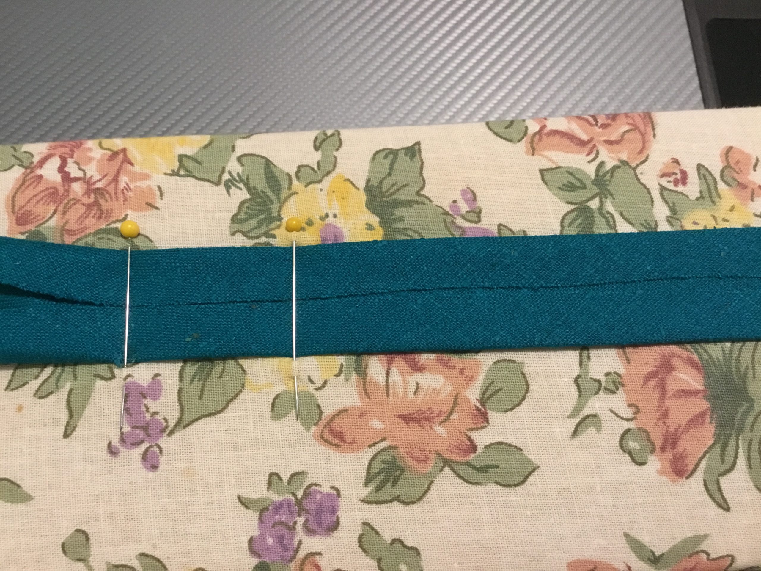 Image of ironing board with pins making bias tape