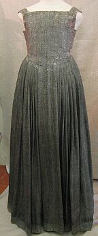 an extant green sleeveless floor length dress with a tight bodice and pleated full skirt attached