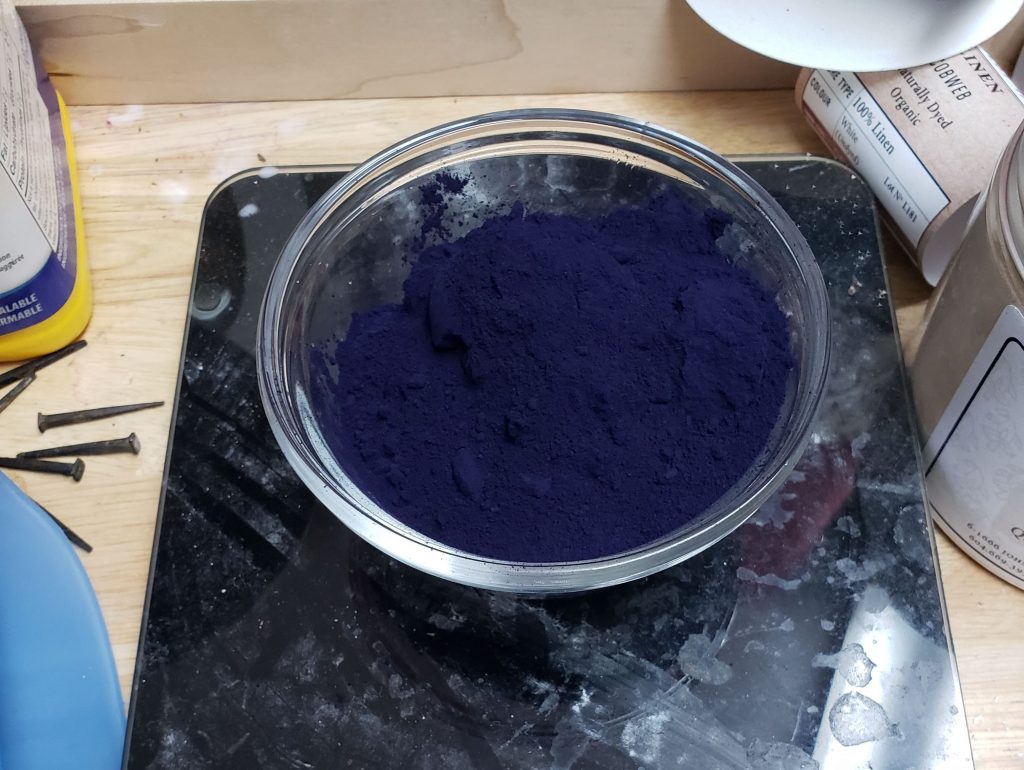 Small glass bowl with blue powdered indigo