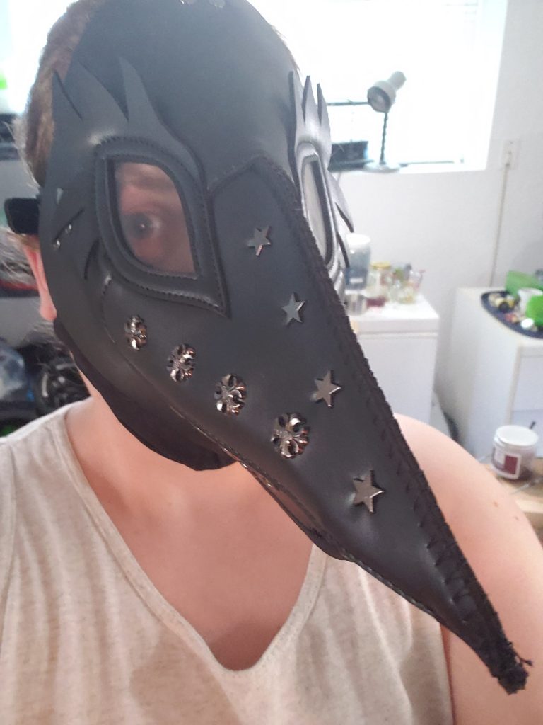 Artisan wearing a plague doctor mask